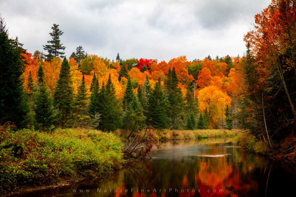 Keene Valley fall colors reflection of trees on water